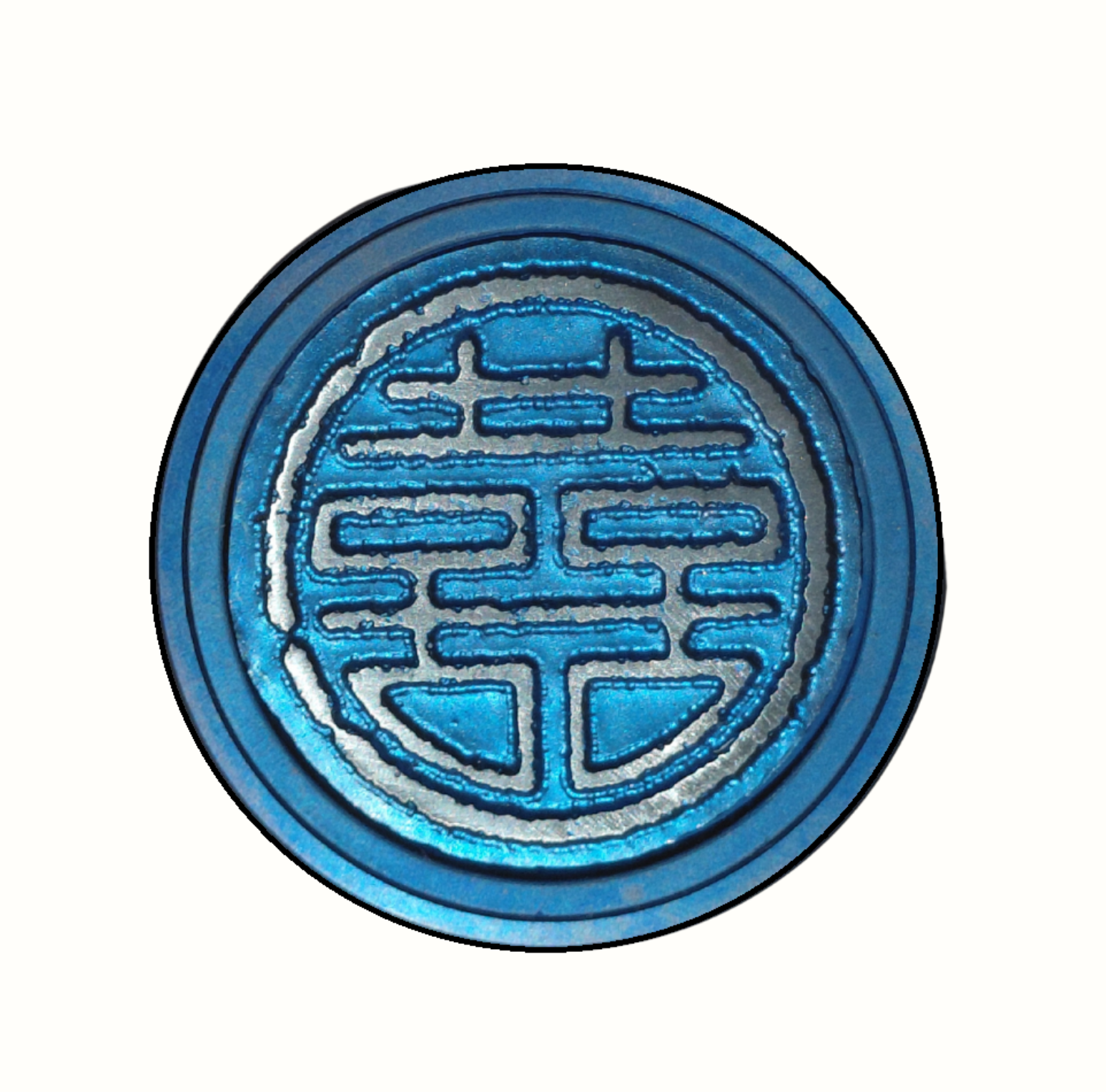 Blue titanium bicycle stem top cap on a white background.