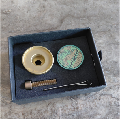 Titanium stem top cap set in a box giftbox on a concrete surface