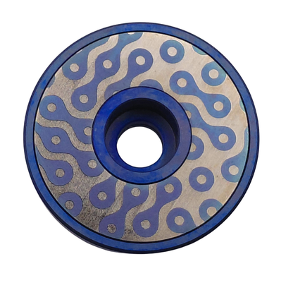 Bicycle chain design, blue titanium Stem top cap on a white background